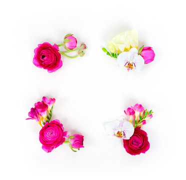 Flowers composition. Frame made of ranunculus and orchidea flowers on white background. Flat lay scene with copy space