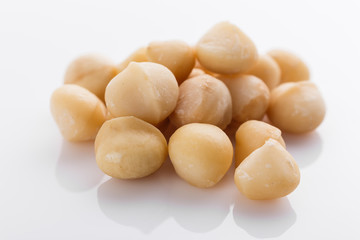 delicious macadamia nuts on a white acrylic background