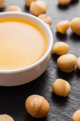 delicious macadamia nuts on a dark stone background