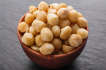 delicious macadamia nuts on a dark stone background