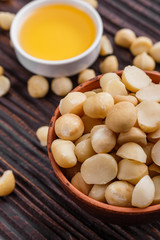 delicious macadamia nuts on a wooden rustic background