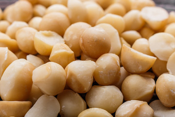 delicious macadamia nuts on a wooden rustic background