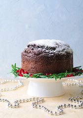 Christmas Cake Decorated with Icing Sugar, Rosemary and Pomegranate