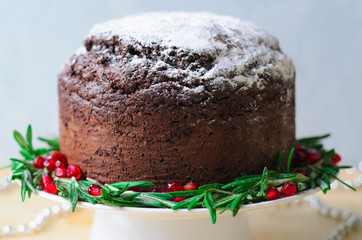 Christmas Cake Decorated with Icing Sugar, Rosemary and Pomegranate