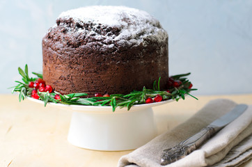 Christmas Cake Decorated with Icing Sugar, Rosemary and Pomegranate