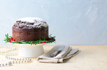 Christmas Cake Decorated with Icing Sugar, Rosemary and Pomegranate