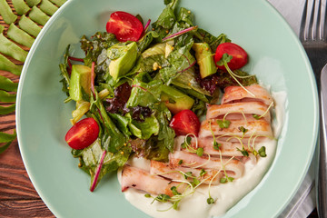 Fried calamari rings with healthy salad and cream sauce