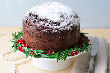 Christmas Cake Decorated with Icing Sugar, Rosemary and Pomegranate