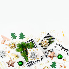 Christmas winter decorations, business stationery and gifts from secret Santa on white background. Office celebration concept. Flat lay, top view.