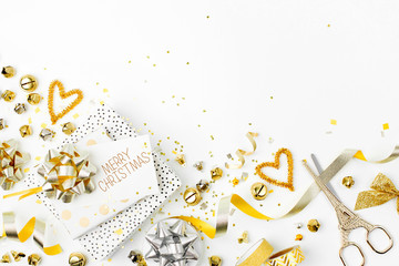 Christmas decorations and gifts in gold colors on white background with empty copy space for text. Holiday and celebration. Flat lay, top view