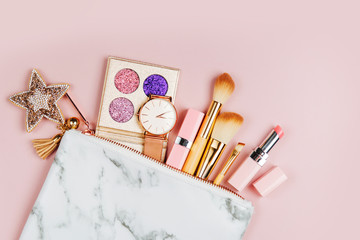 Cosmetic bag with beauty accessory and makeup product. Flat lay