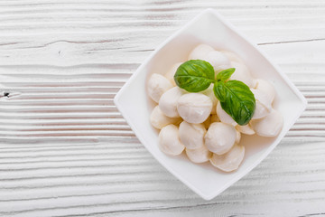 Mozzarella tomatoes and basil on a wooden rustic background