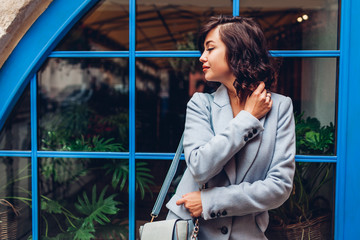 Beautiful young woman wearing stylish autumn outfit. Outdoor portrait of fashion model