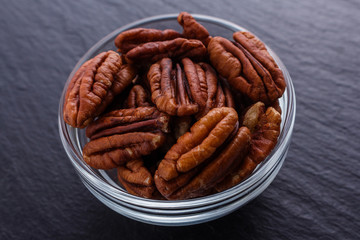 delicious pecan nuts on a dark stone background