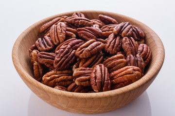 delicious pecan nuts on a white acrylic background