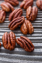 delicious pecan nuts on a rustic wooden background