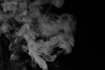 Fototapeta premium White smoke on a black background. Texture of smoke. Clubs of wh