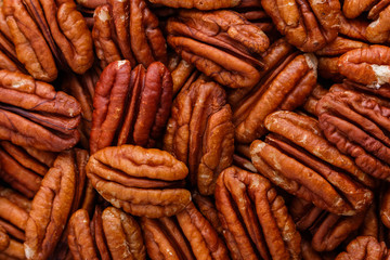 delicious pecan nuts on a dark stone background