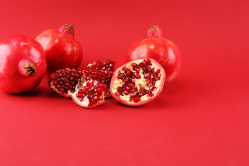 Ripe Pomegranates. sliced and whole pomegranate on a table.