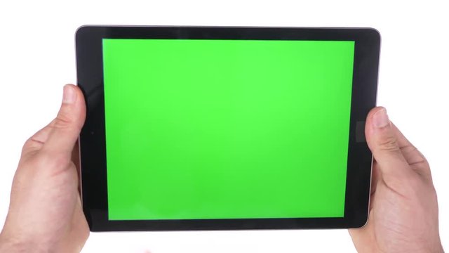Holding a tablet device with a green screen no gestures on pure 100% white background.