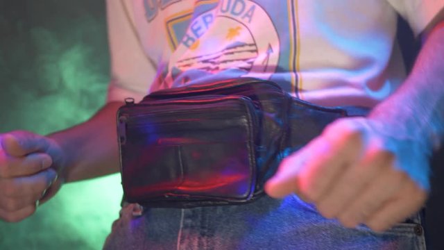 Retro gamer in the 80s 90s using a controller to play a video game. Neon lighting arcade style