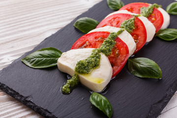 Caprese salad on a wooden rustic background
