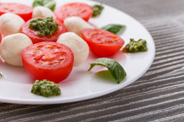 Caprese salad on a wooden rustic background
