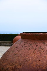 Roman pot against a brilliant pale blue sky