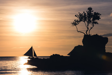 Boracay's grotto on the sunset with sailboats on the background