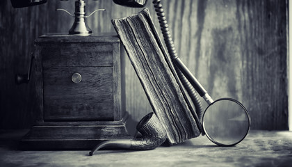 Old telephone and retro book on the desk. The phone of the past 
