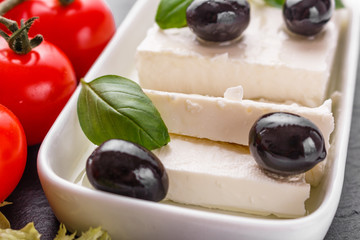 A piece of feta cheese on a wooden rustic background