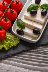 A piece of feta cheese on a wooden rustic background