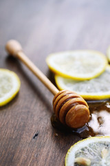 On a wooden texture background a lemon and honey