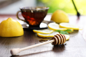 Fresh honey with a cup of black tea