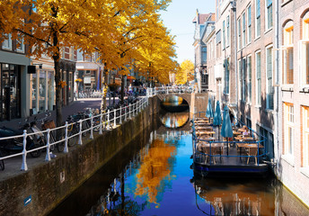 street with canal in Delft old town in Holland at fal