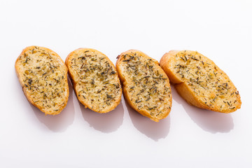 fragrant garlic bread on a white acrylic background