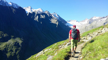 Austria. Alpine region "Stubai". The Oberbergtal Valley. Climber on a mountain path.