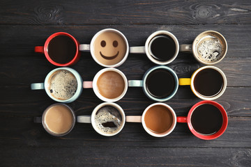 Flat lay composition with cups of coffee on wooden background. Food photography