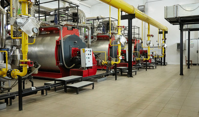 Modern new gas heating coppers work in a boiler room.