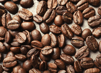 Roasted coffee beans on grey background, closeup