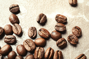 Roasted coffee beans on grey background, closeup