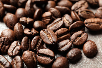Roasted coffee beans on grey background, closeup