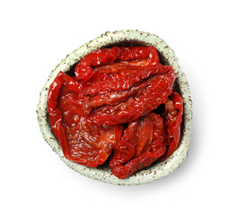 Bowl with sun dried tomatoes on white background, top view