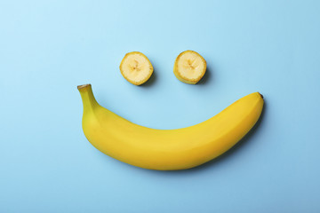 Funny flat lay composition with bananas on color background