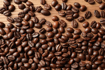 Roasted coffee beans on wooden background, top view