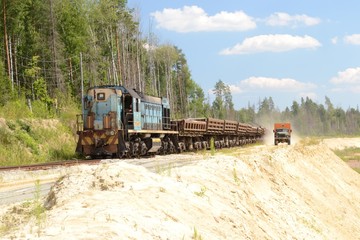 Fototapeta na wymiar race between a freight train and a truck