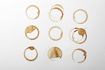 Dried coffee cup stains on white background, top view