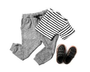 Flat lay composition with cute child clothes and shoes on white background