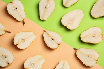 Flat lay composition with halves of fresh ripe pears on color background