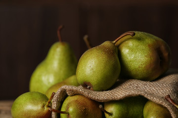 Fototapeta na wymiar Fresh ripe pears against dark background, closeup view